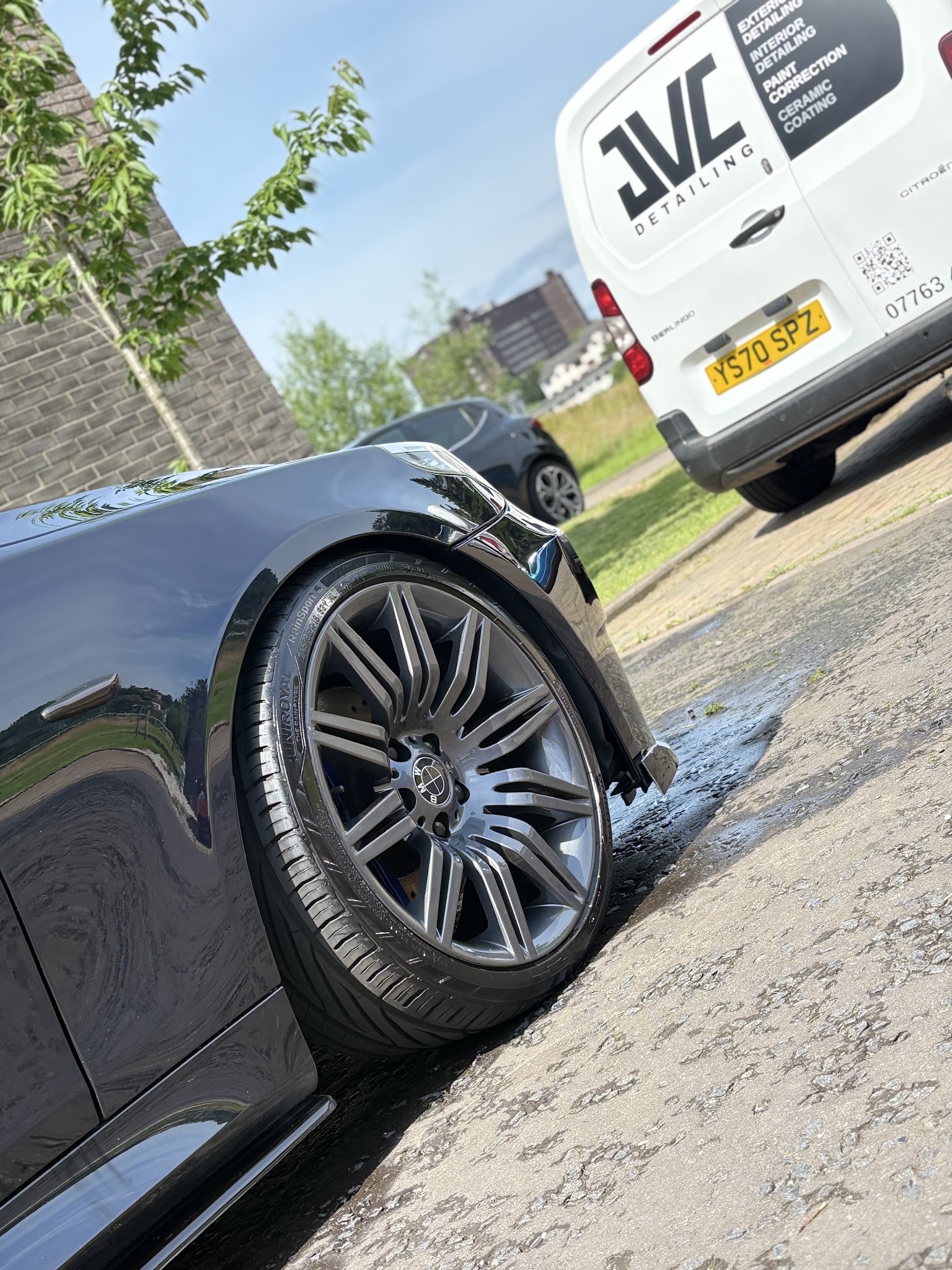 The JVC Detailing van parked beside a freshly washed dark BMW