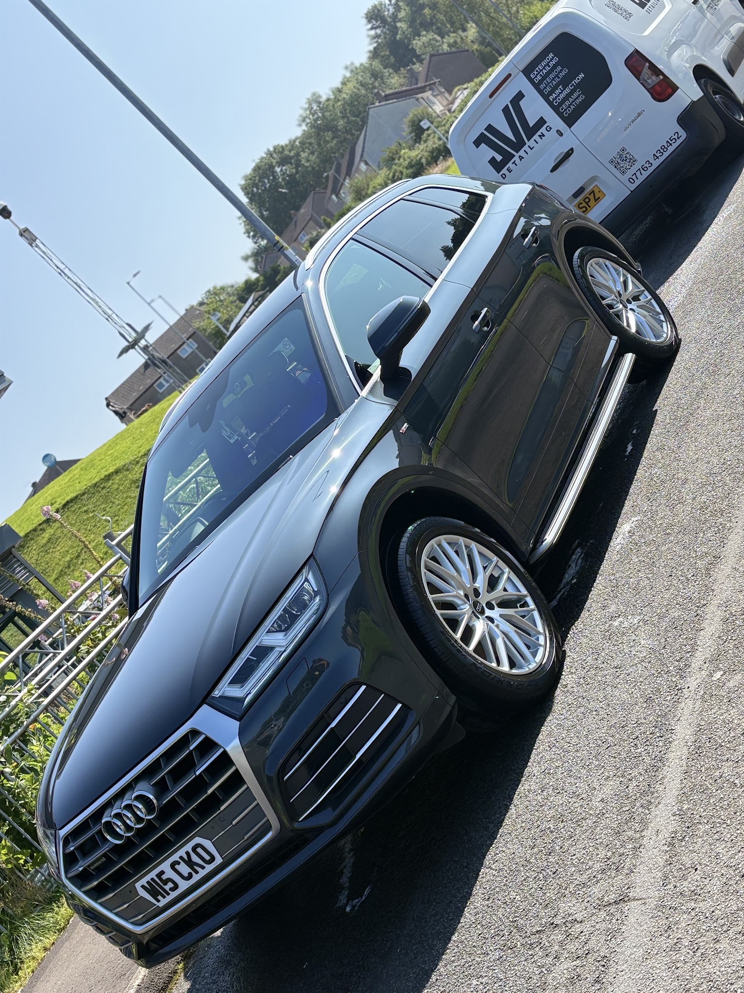 A grey Audi Q5 after a wash, with the JVC Detailing van behind it
