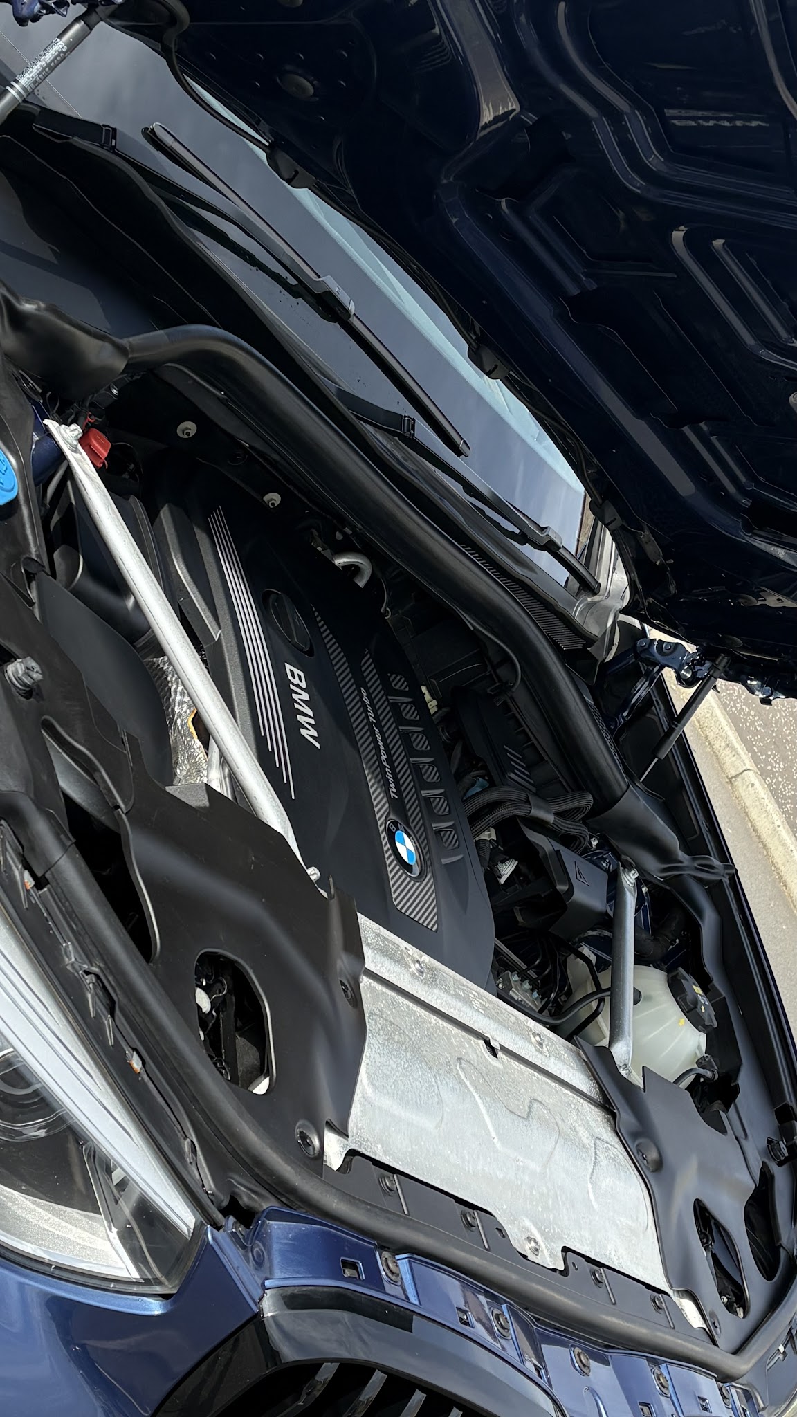 A cleaned BMW engine bay with the bonnet open