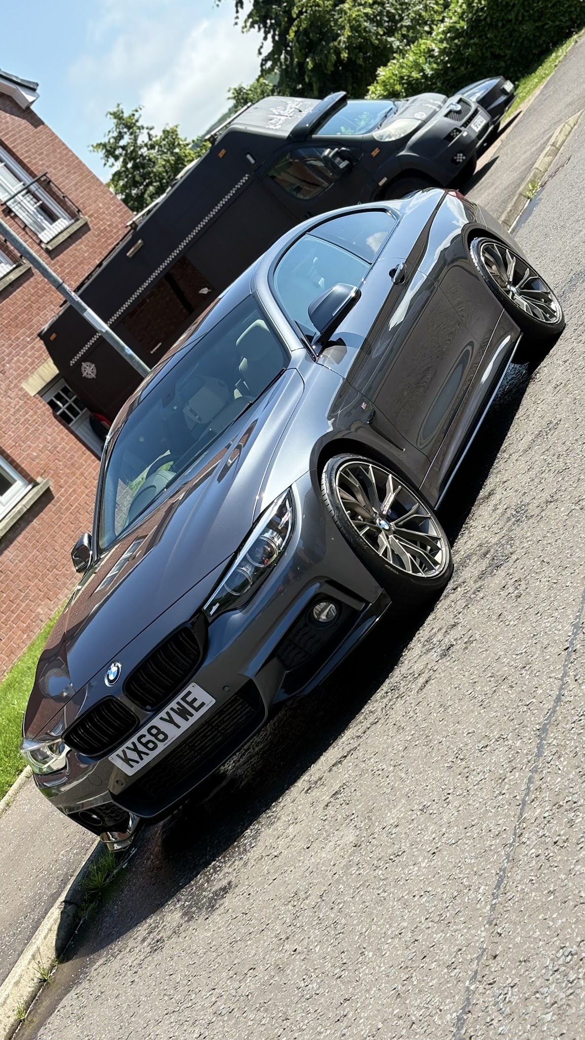A grey BMW coupé parked on the street after detailing